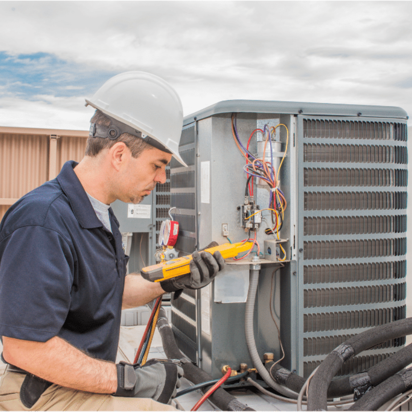 Kitchener Heating & Cooling HVAC technician servicing a system